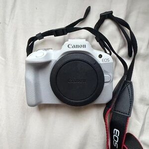 Canon White EOS Mirrorless Camera Body with Black Cap and Strap